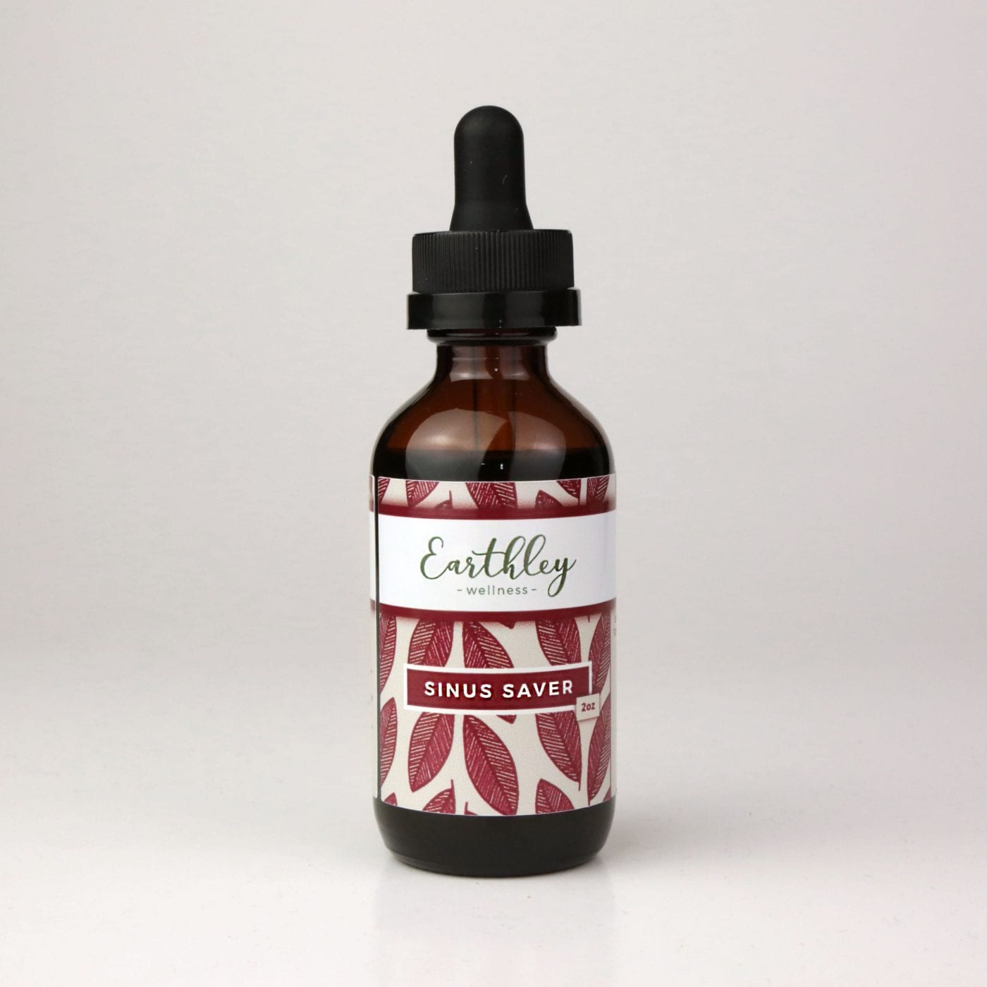 Earthley Sinus Saver tincture in a 1 oz amber dropper bottle with maroon leaf-patterned label, photographed against a clean white background.