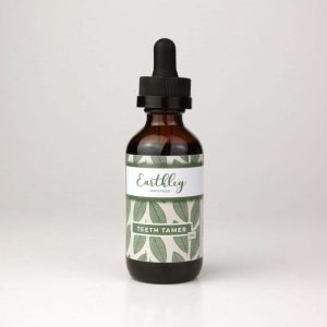 Earthley Teeth Tamer herbal tincture in a 1 oz amber glass dropper bottle with green leaf-patterned label, photographed on a white background.